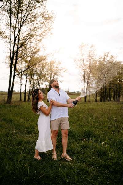 Couple popping champagne for Chicago engagement photos