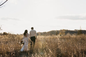 Newlywed couple walking through Indiana Dunes beach