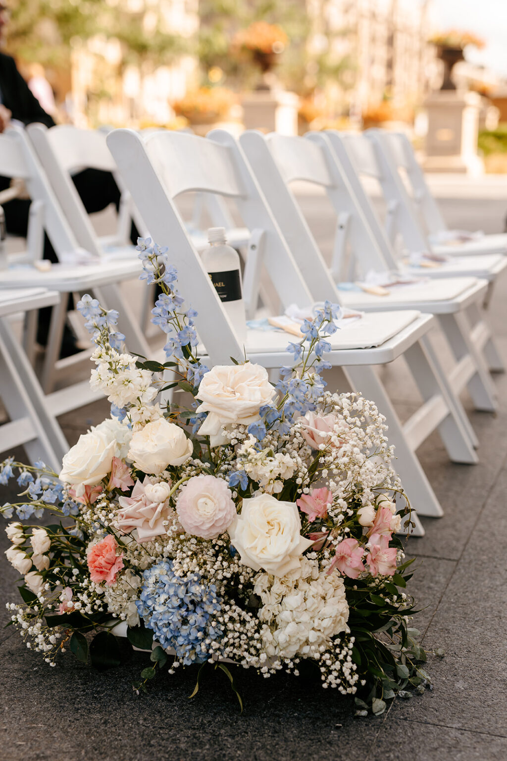 Pastel wedding florals beside ceremony chairs in Carmel Indiana