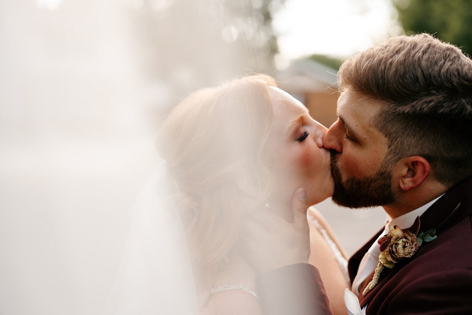 4. Newlyweds sharing a golden-light kiss at their Algonquin backyard wedding
